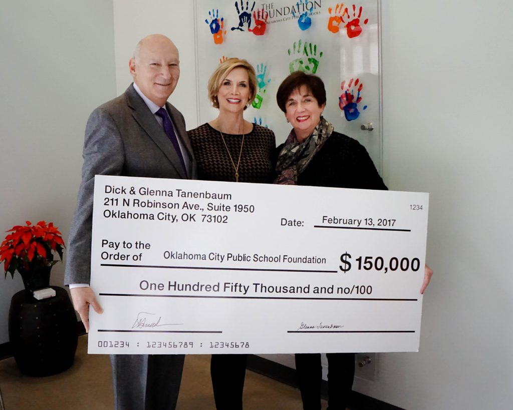 Glenna and Dick Tanenbaum holding check for $150,000