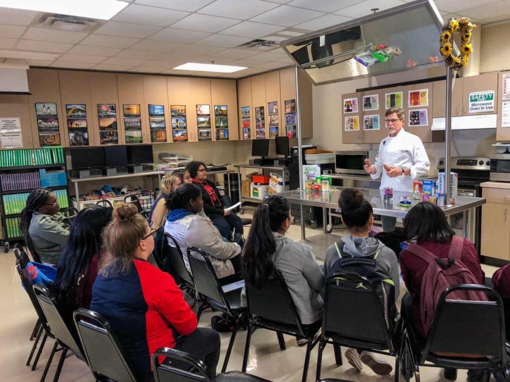 Rick Bayless doing demonstration for students in classroom