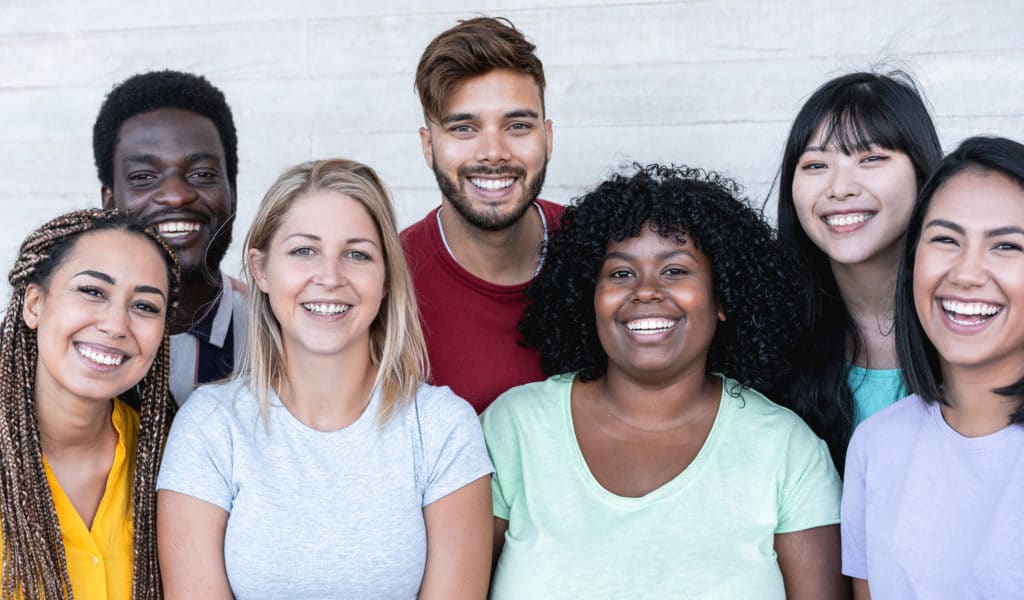 diverse group of men and women laughing