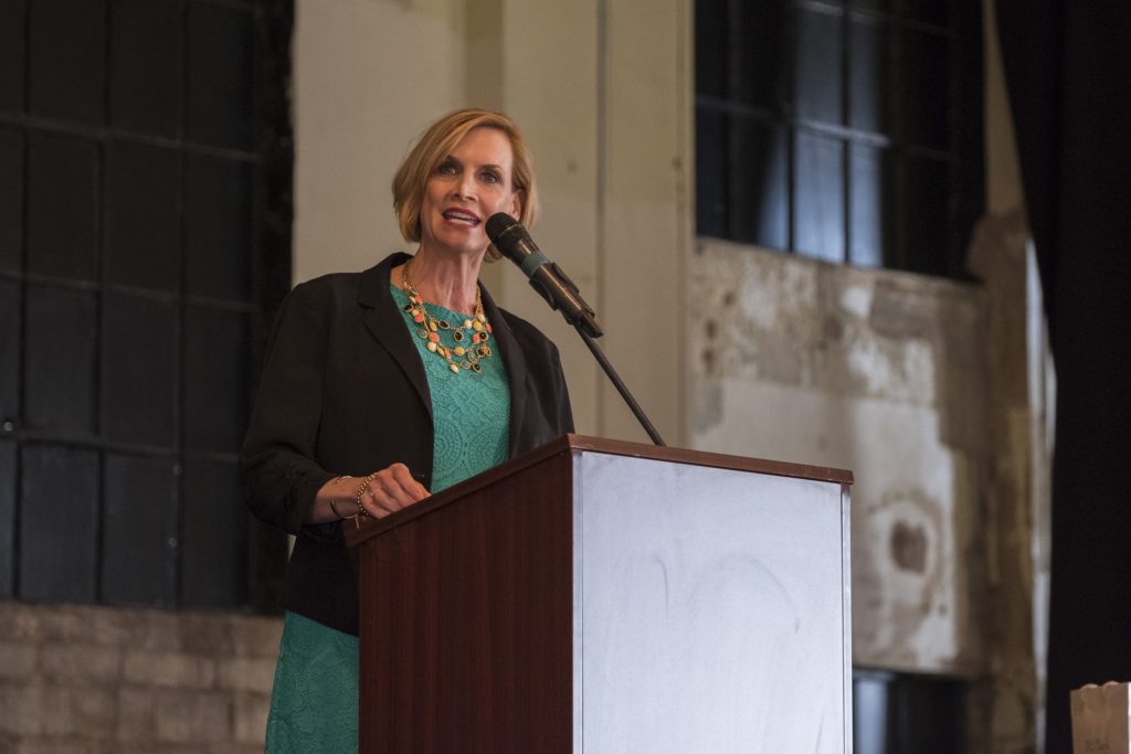 Mary Melon speaking at podium