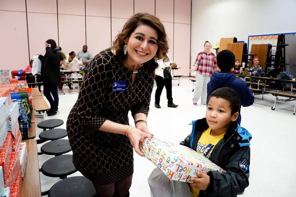 Foundation employee giving student a gift