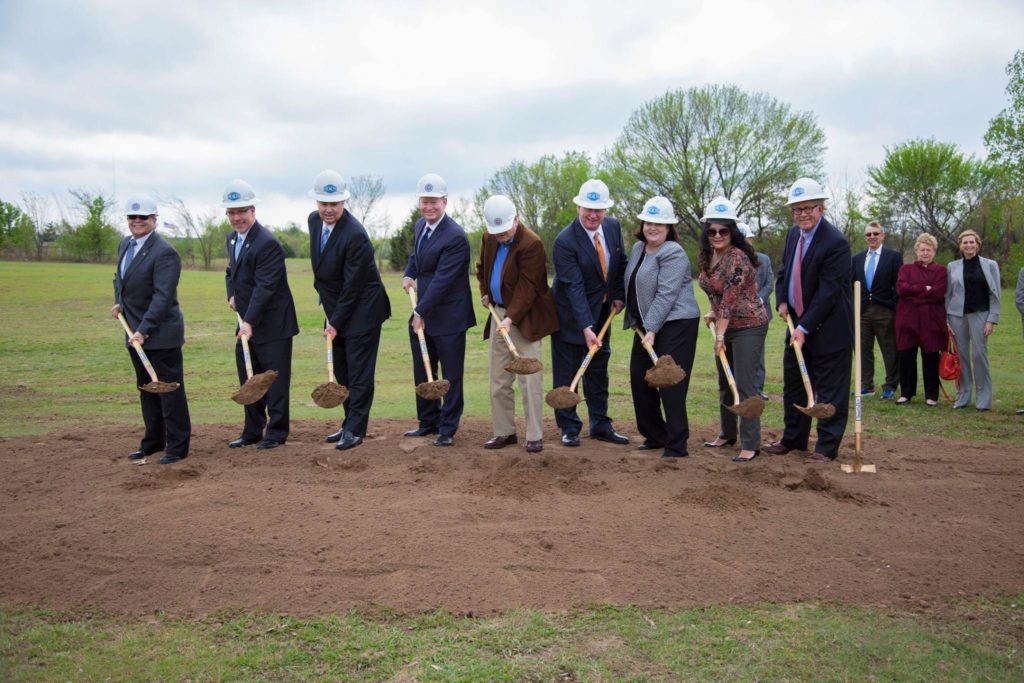 a group of people wearing hard hats and holding shovels at the Southern Oaks groundbreaking