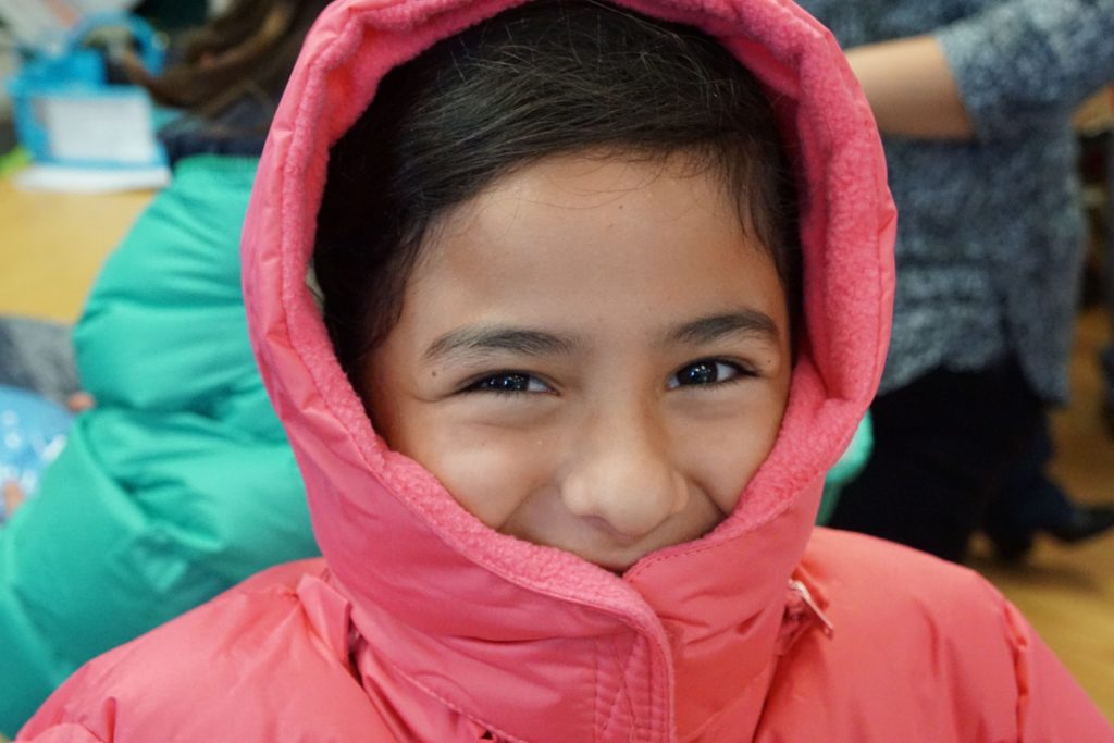 girl smiling in puffy jacket