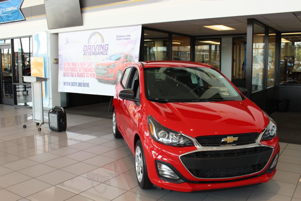 red chevy car parked inside dealership